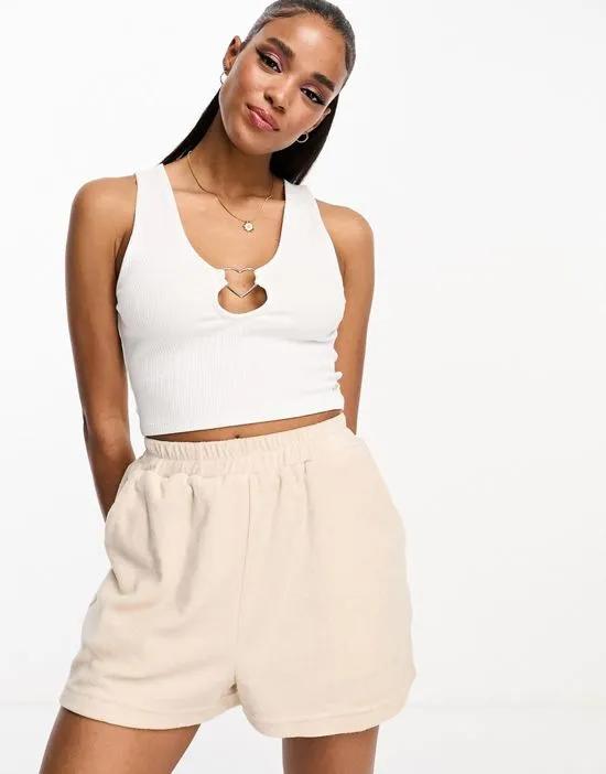 tank top with heart shaped ring detail in white