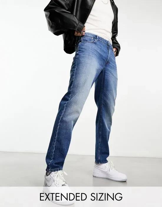 tapered jeans in mid wash blue