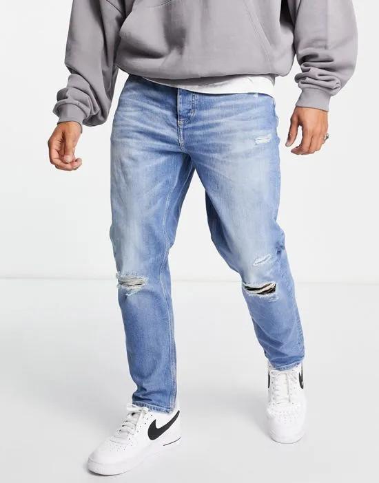 tapered jeans with rips in light blue