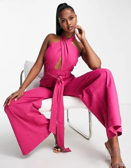 textured halter jumpsuit with belt and large pocket in bright pink