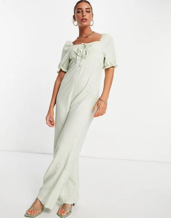 textured jumpsuit with tie detail in green gingham