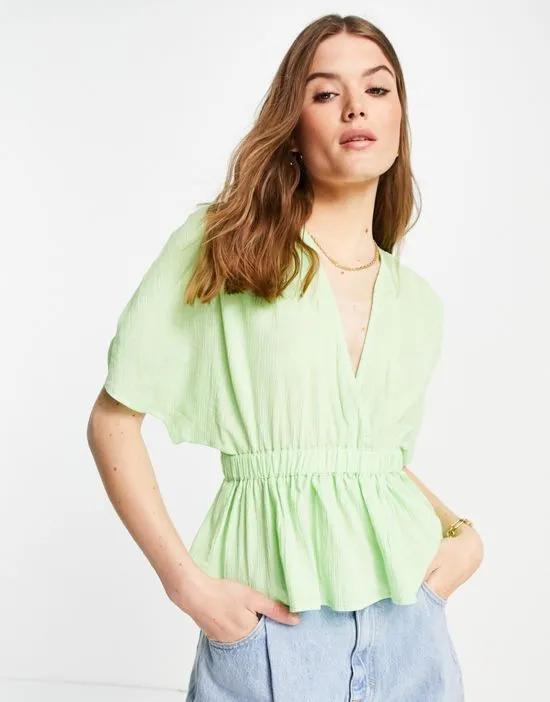 textured plunge front top with elastic waist detail in apple green