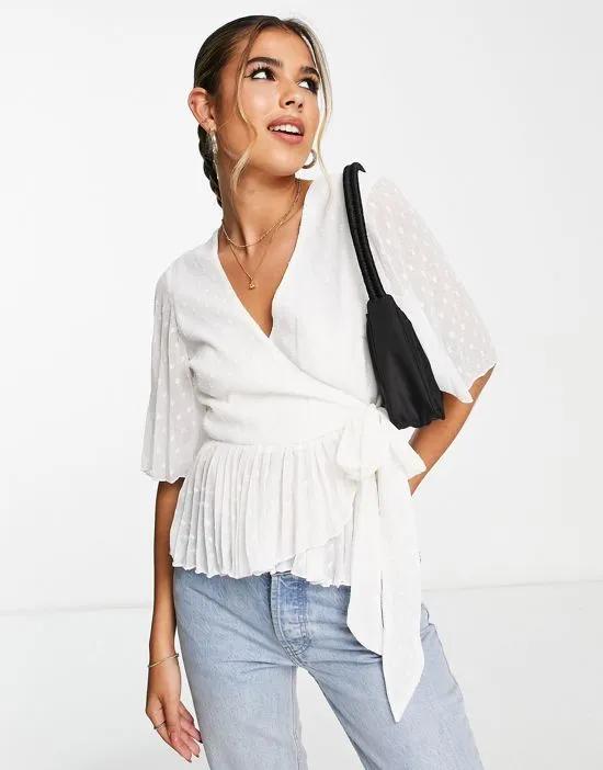 textured wrap short sleeve blouse with pleated peplum hem in ivory