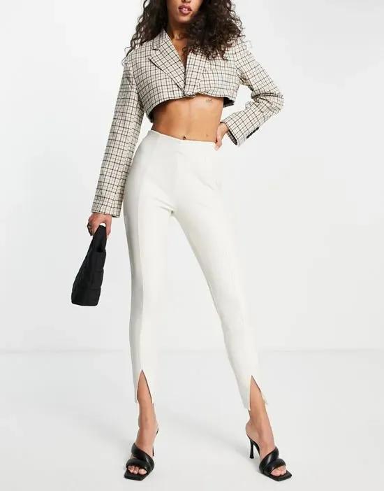 Topshop faux leather skinny pants with front hem slits in off white