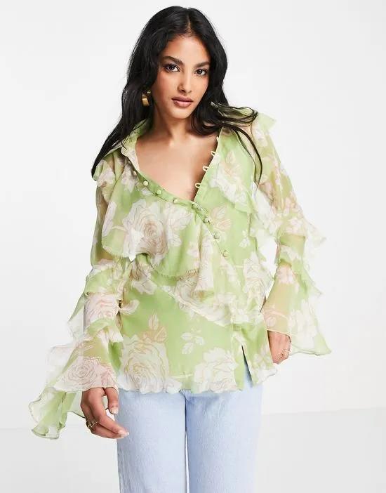 v neck ruffle blouse with frill detail and button edge in green floral print