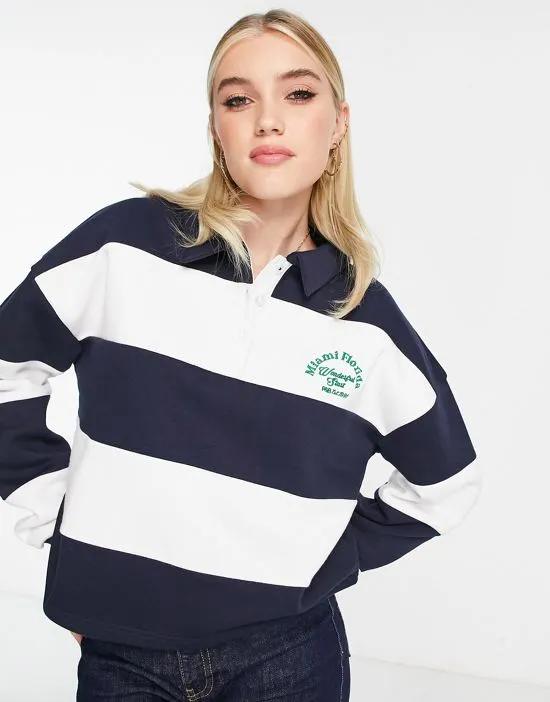varsity striped polo shirt with logo detail in navy and white