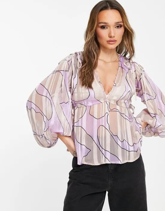 volume long sleeve with tie detail and pelum hem in abstract swirl print