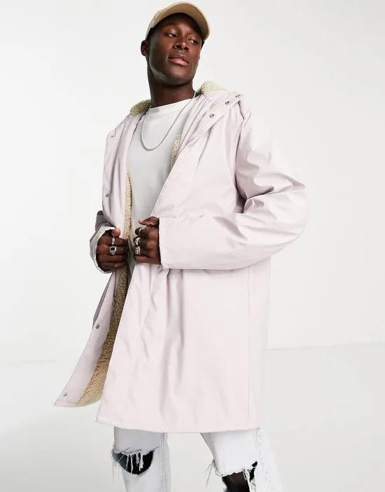 water resistant rubberized rain jacket in pink with teddy borg lining