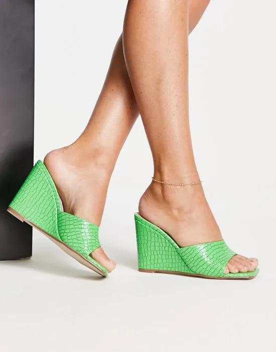 wedge mules in green faux croc