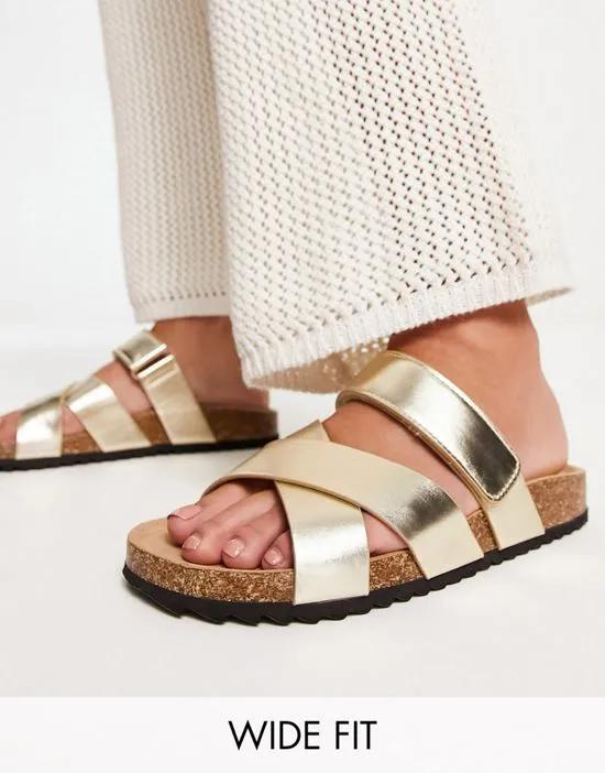 Wide Fit Fiery cross strap flat sandals in gold