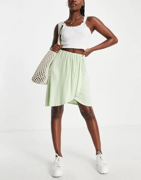 wrap front mini skirt in pale green