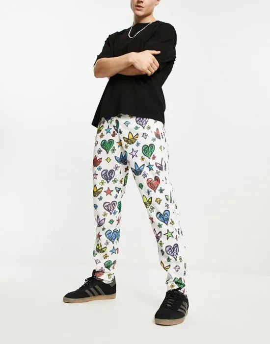x Jeremy Scott Firebird track pants in all over print in multi